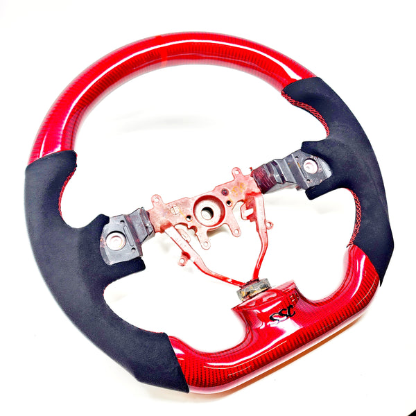 SSC V2 BLACK ALCANTARA/RED CARBON FIBER STEERING WHEEL WITH RED STITCHING- 08-14 IMPREZA WRX/STI, 08-09 LEGACY/OUTBACK, 09-13 FORESTER